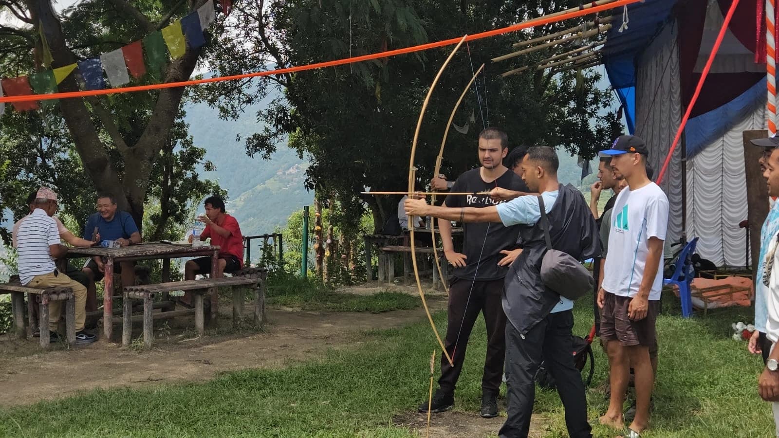 Team members watching an archery activity at Tarevir